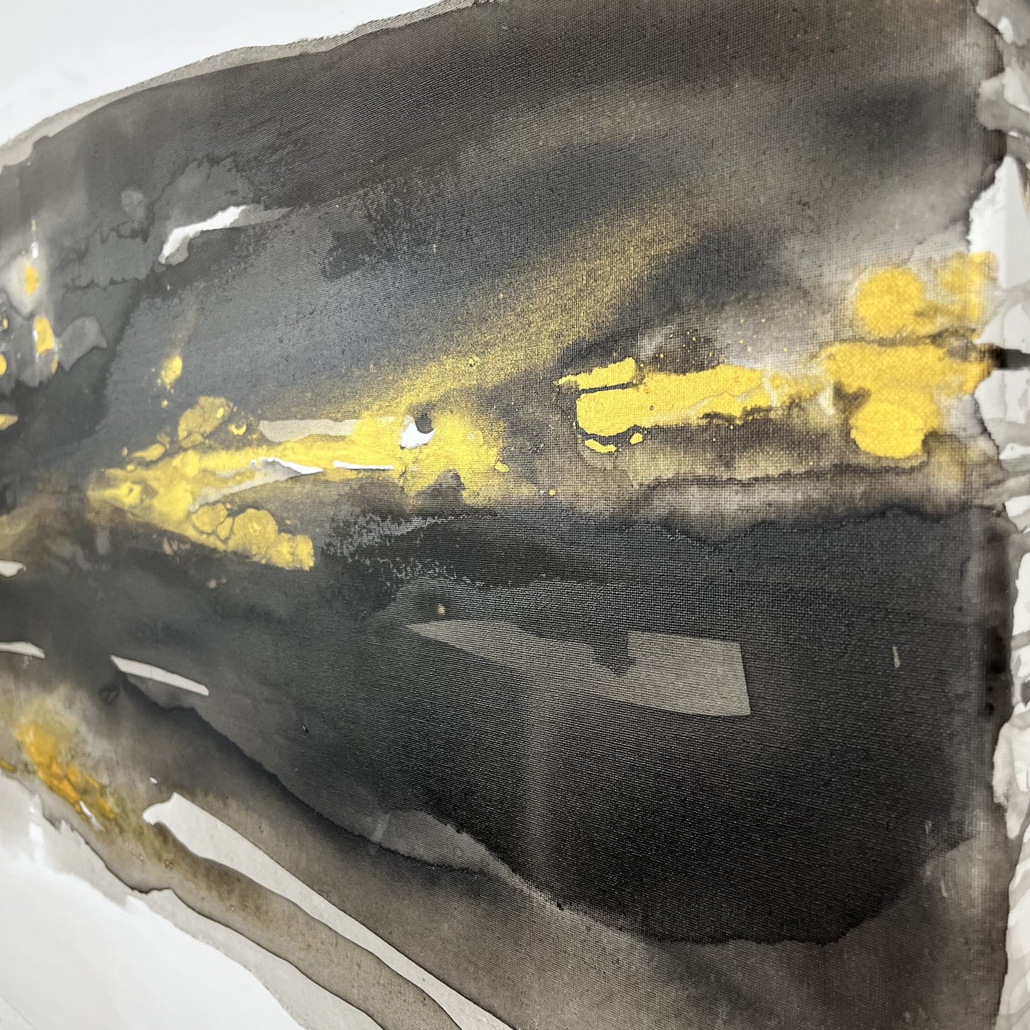 Abstract painting in black, gray, and gold tones by Charlotte George, Earth’s Whisper III, evoking molten movement and the deep pulse of the earth