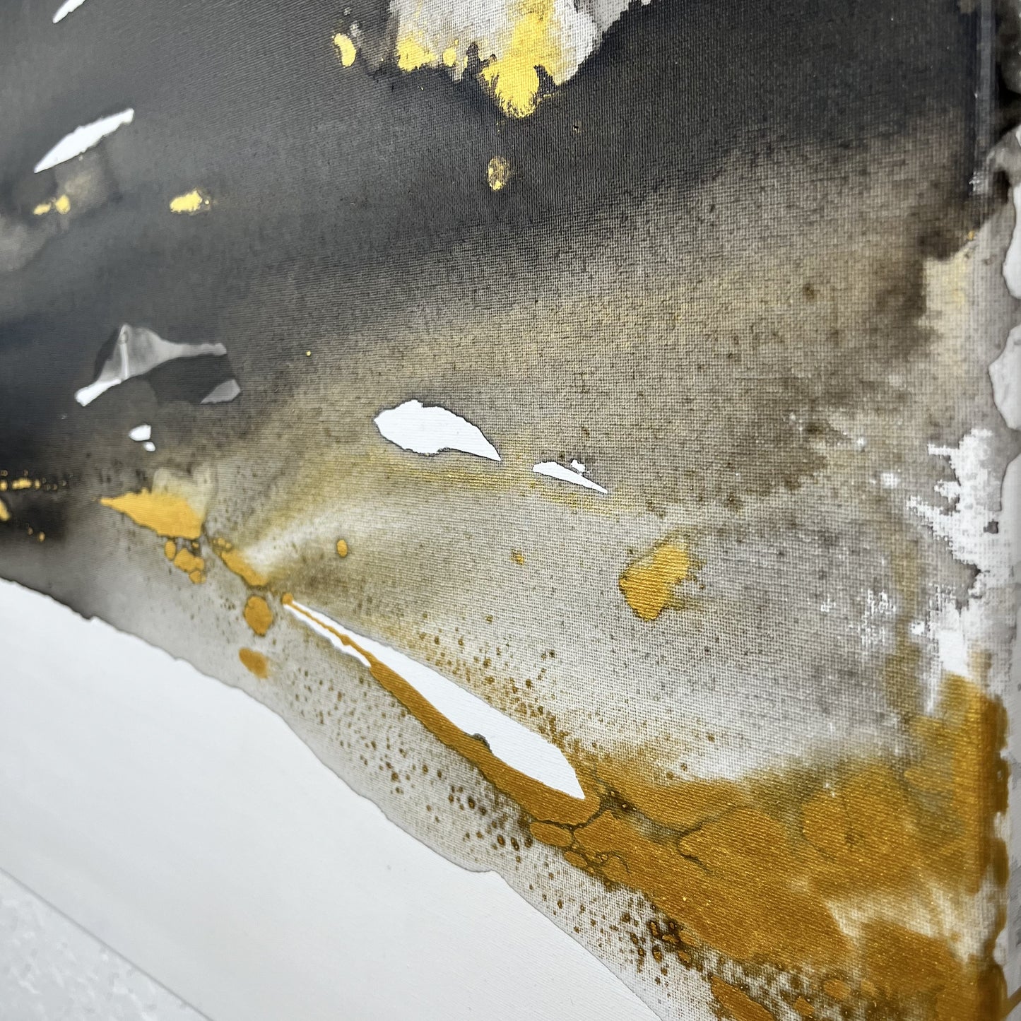 Abstract painting in black, white, and gold tones inspired by the movement and hidden elements of the earth, Earth’s Whisper II by Charlotte George.