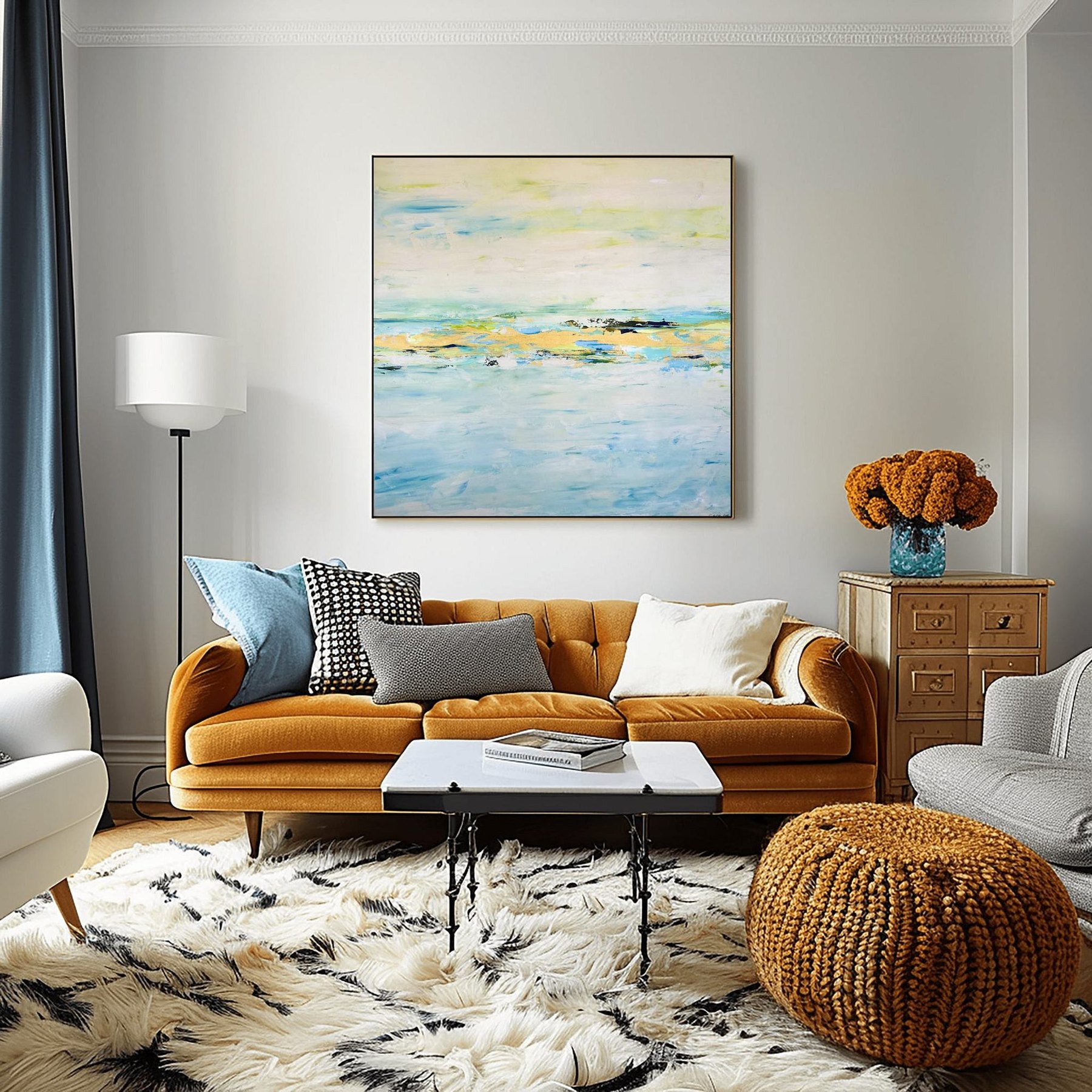 Charlotte George, River's Return abstract landscape in blue and gold, framed above a tan sofa