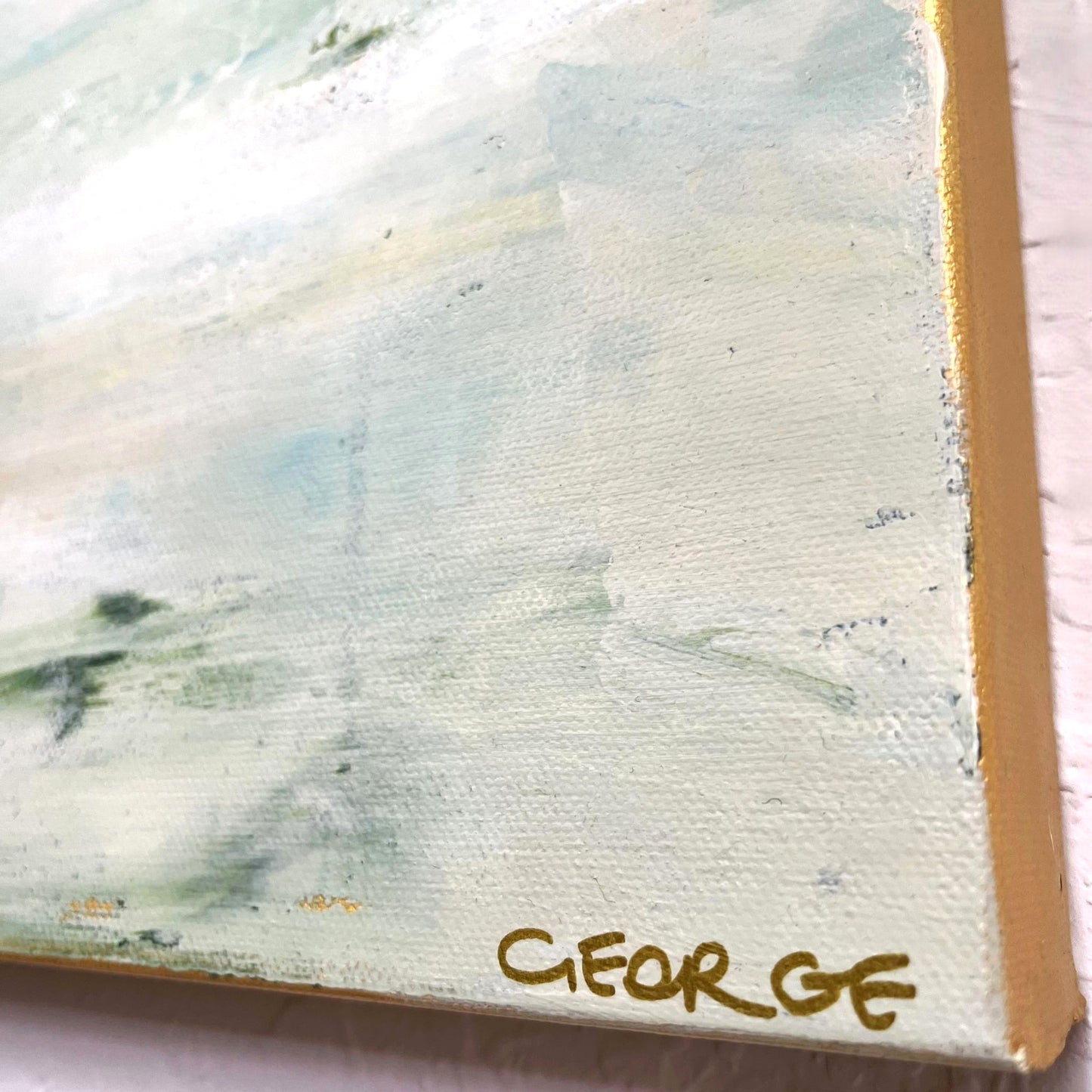Calm abstract landscape in natural hues of green, beige, and slate blue by Charlotte George, evoking the movement of water and land